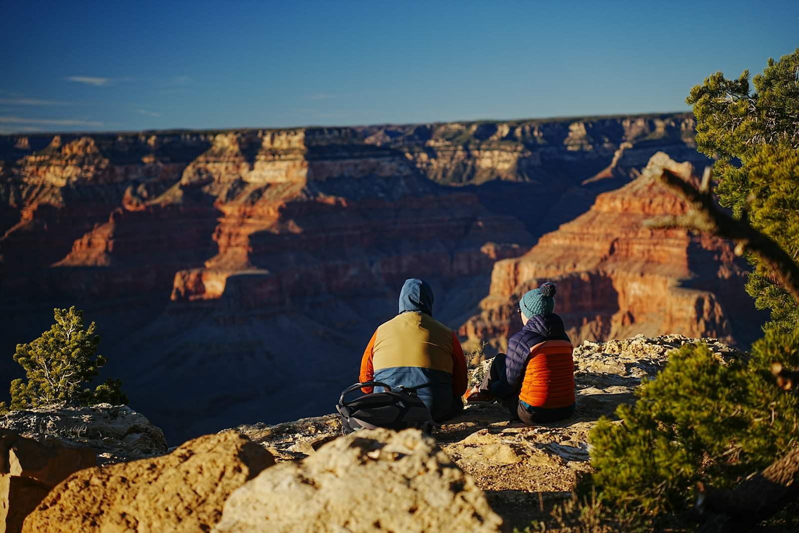 Older visitors enjoying a desert view from a shaded bench